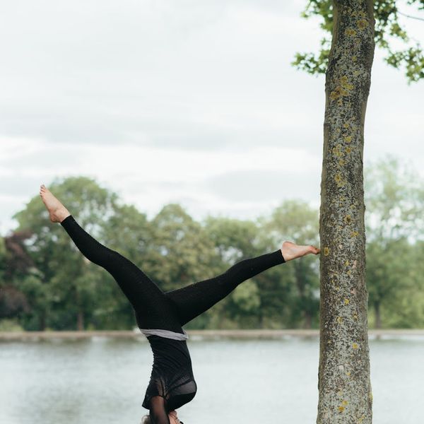 Woman performing a gentle stretching exercise, radiating vitality and health.